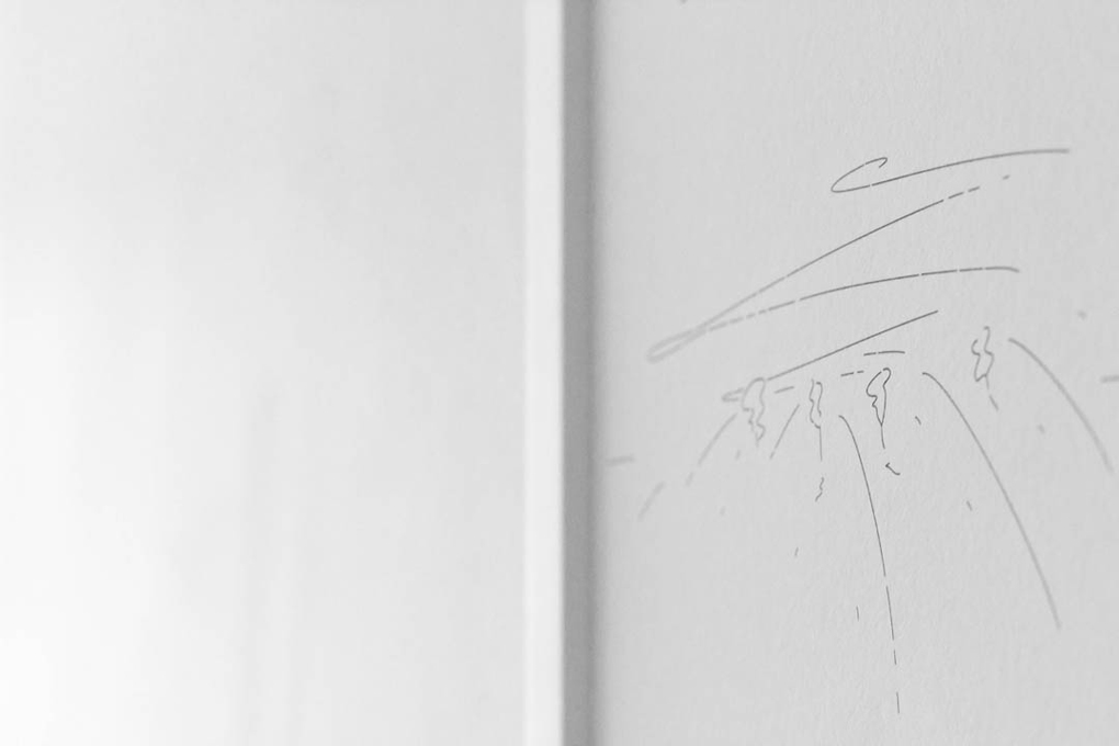 Detail shot of an abstract black and white landscape drawing in a white frame.