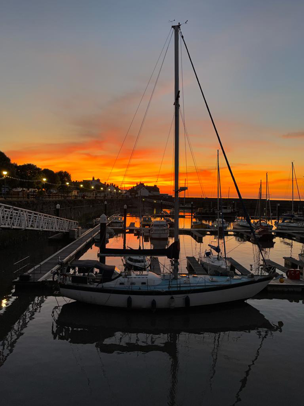 Brilliant red and gold sunset over a quay