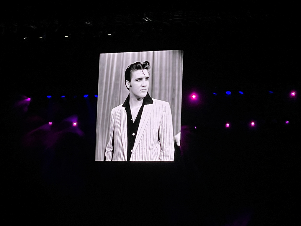 Black and white image of Elvis Presley projected on a screen