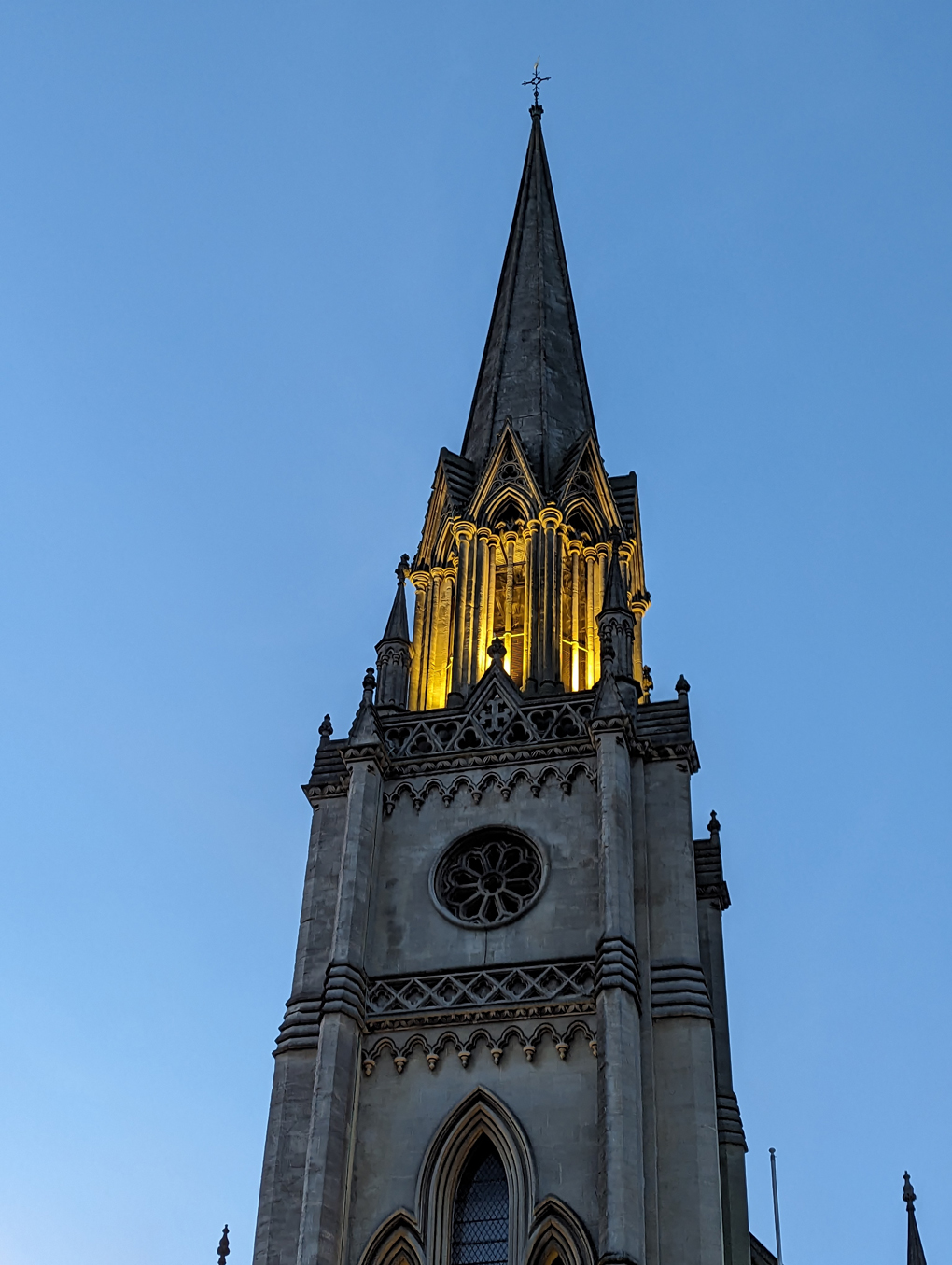 Church tower lit up at dusk