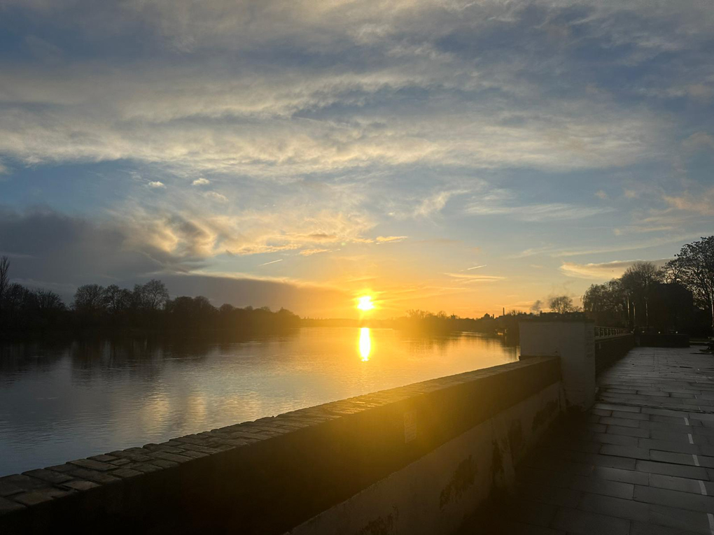 Sun setting over a river