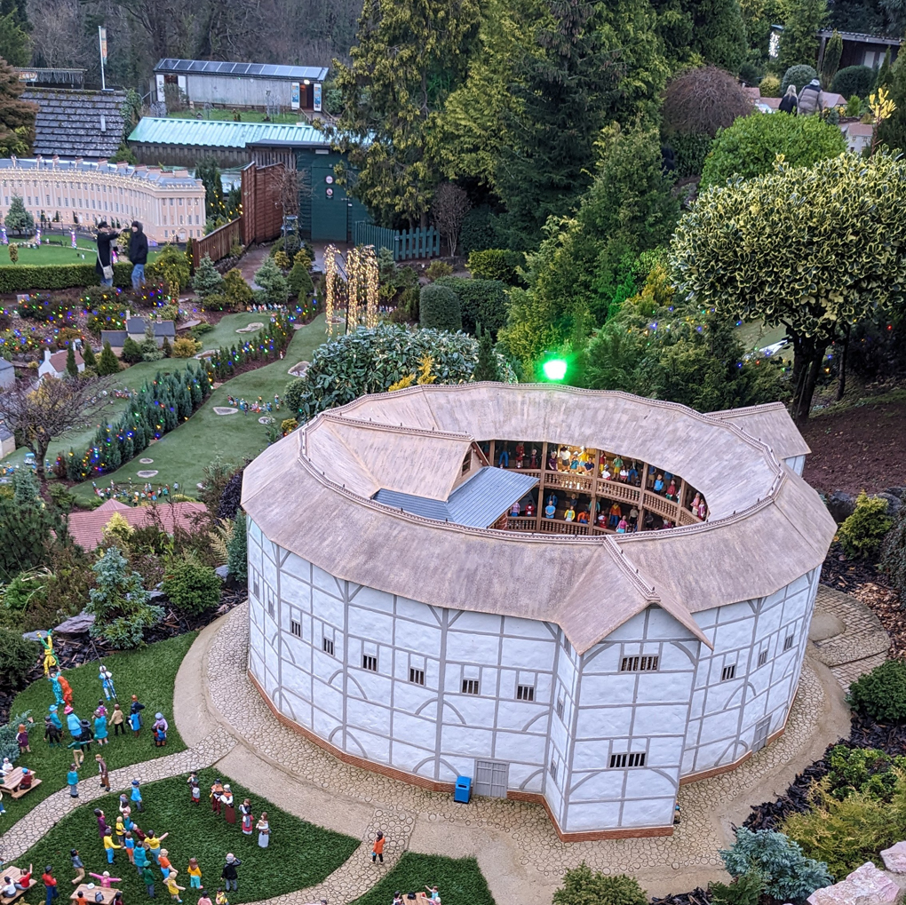 Model village featuring The Globe theatre in foreground, a golf course (with model players) behind and a miniature, replica 19th century crescent behind that.