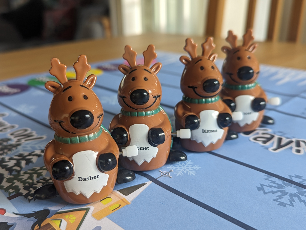A line of plastic reindeer toys with wheels and wind up mechanisms