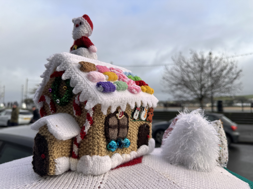 Handmade post box topper, showing a house with santa on the roof