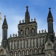 Two people and dogs stood in front of a hide cathedral frontage