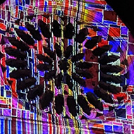 Colourful animated light projection on the front of York Minster at night
