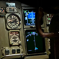 A small boy sat in the co-pilot seat of a aircraft cockpit