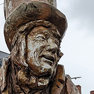 A wooden carving of the Mad Hatter from Alice in Wonderland