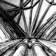 Black and white photo of one of the cathedral pillars that support the stunningly intricate stone roof of the cathedral.