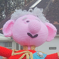 A knitted King Charles atop a post box