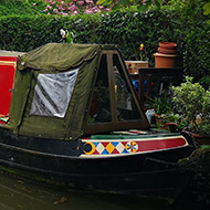 Canal boat on Oxford canal with trees.