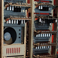 Multiple tall cabinets with racks of vacuum tubes, dials, switches and what might be an oscilloscope display make up a replica of the 1948 computer Baby, originally built by Manchester University and the precursor to the Manchester Mark 1