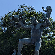 A statue of a man seemingly fighting off four babies