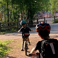 Two children cycling in a park