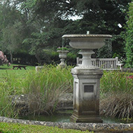 Formal Georgian garden with fountain and summer flowers