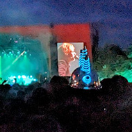 Giant screen over a music festival in the dark