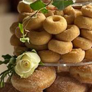 A wedding cake made from assorted donuts.