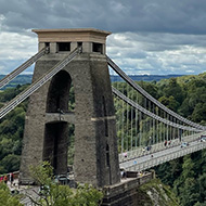 A suspension bridge over the Avon gorge. Cloudy skies above