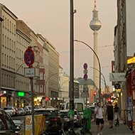Street view at dusk with Alexanderplatz tv tower in the background.