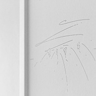 Detail shot of an abstract black and white landscape drawing in a white frame.