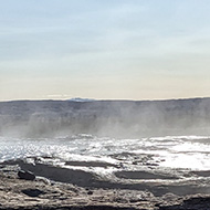 A giant rock pool of steaming water on a sunny autumn day