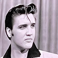 Black and white image of Elvis Presley projected on a screen