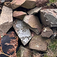 A dry stone wall partially composed of used rubber tyres