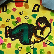 A pile of multi-coloured, torn-up post it note. In the middle of the pile is a drawing of a person curled up asleep. Next to the sleeping person there is text that reads “The designer is hibernating in a nest of post-it notes”