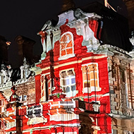 Waddesdon Manor being projected on with a colourful advent calendar.