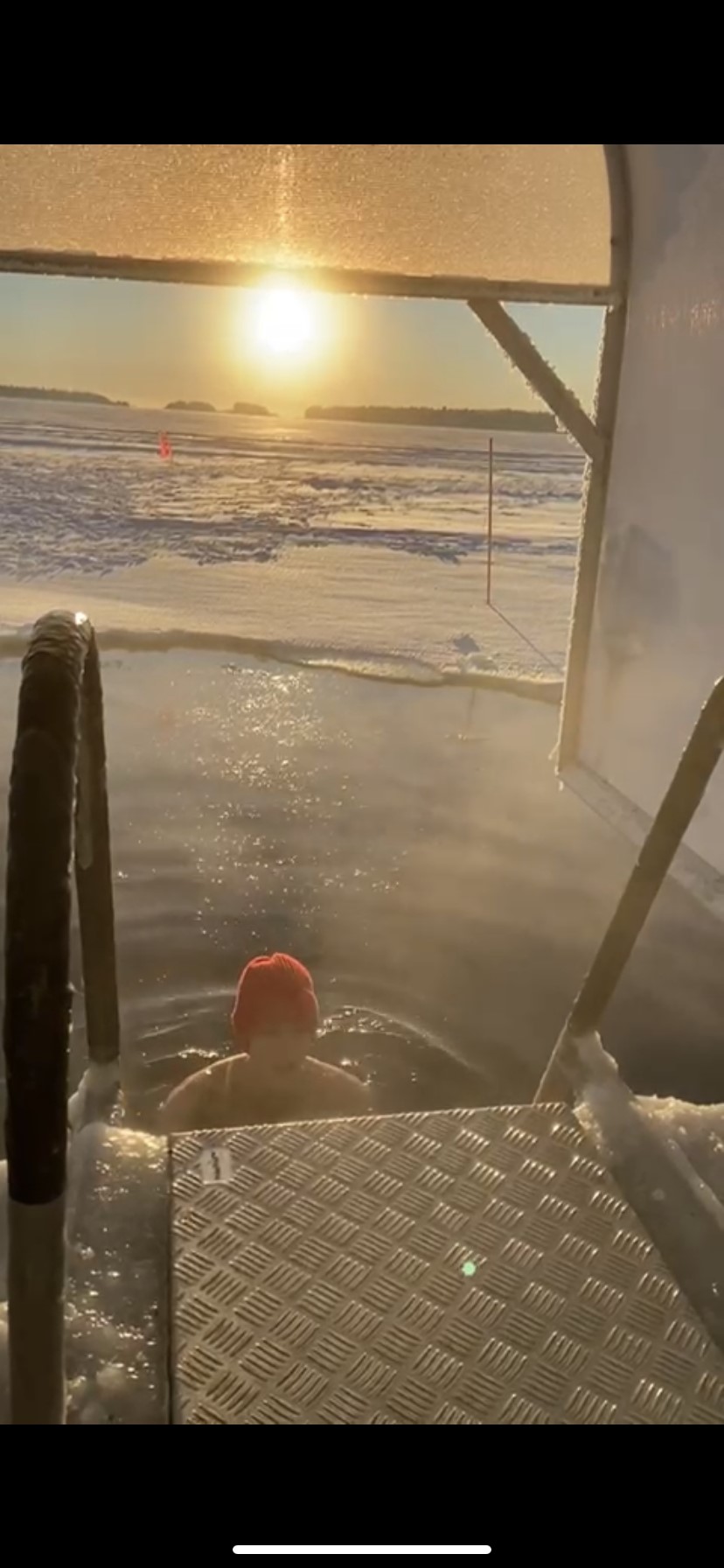 A person in the water in a sunny winter landscape