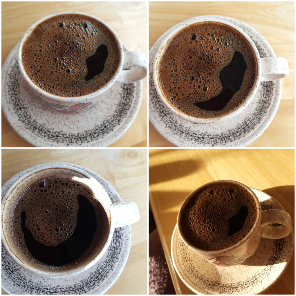 Four coffee cups with frothy cartoon faces