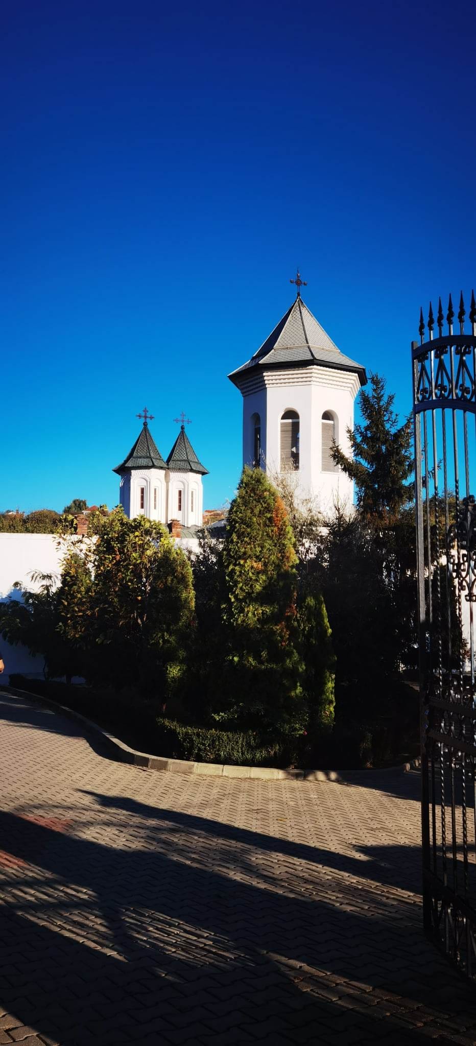 Church towers behind gates alongside a path