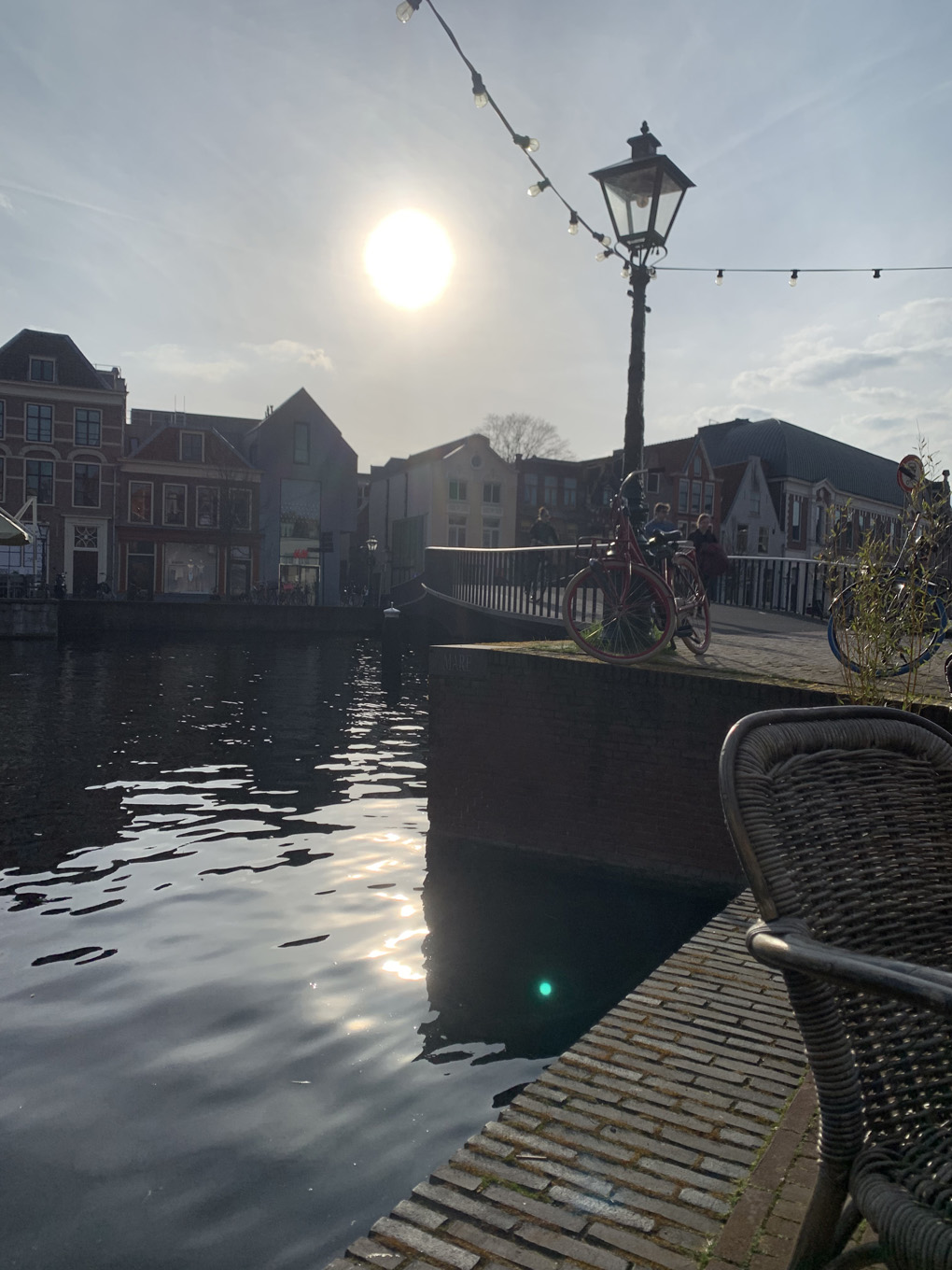 View of a canal and a bridge in the sun.