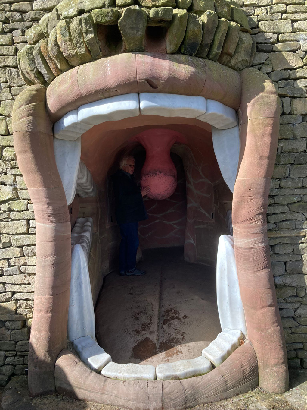 Giant mouth which is a door with a person inside.
