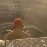 A person in the water in a sunny winter landscape