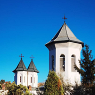 Church towers behind gates alongside a path