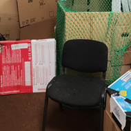 Boxes and boxes of cardboard lie across the floor and tables to form a fully enclosed caving system