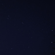 Abstract photo of sky, aerials, wall, with a few stars from Ursa Major in the middle.