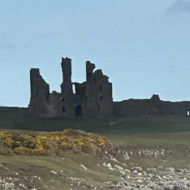 We see a view from Craster to Dunstaburgh Castle, Northumberland coast