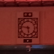 The interior of the BBC Radio Theatre as seen from the stage. About 200 empty red seats and a control room at the back.
