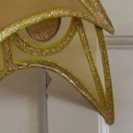 Costume wings hanging on a door labelled Fairy Factory