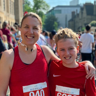 a picture of my wife and son standing at the start of the kids 3K surrounded by hundreds of people!