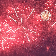 Red fireworks over a field