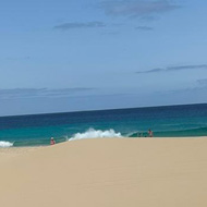Sandy beach with blue sea and sky