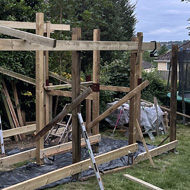 A half-built shed in a garden