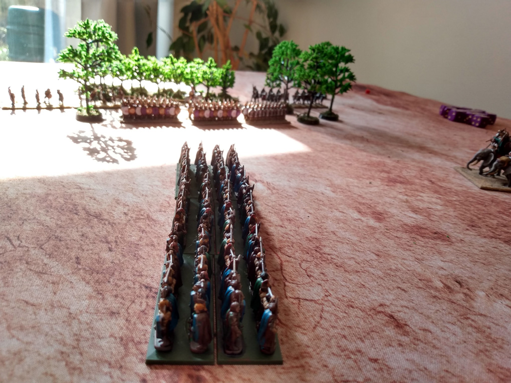 Small plastic models emerge from the woods into the flank of some other small models