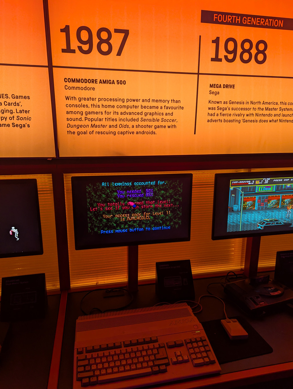 An Amiga 500 under a sign describing the wonders of gaming in 1987