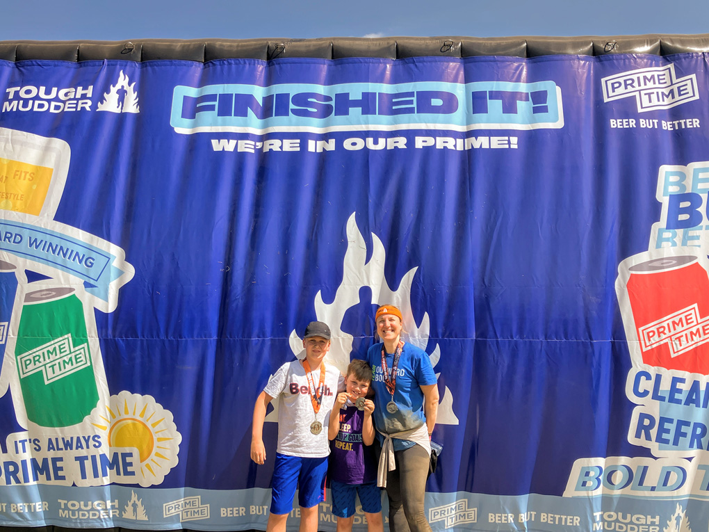 My wife and kids with their participation medals around their necks in front of the 