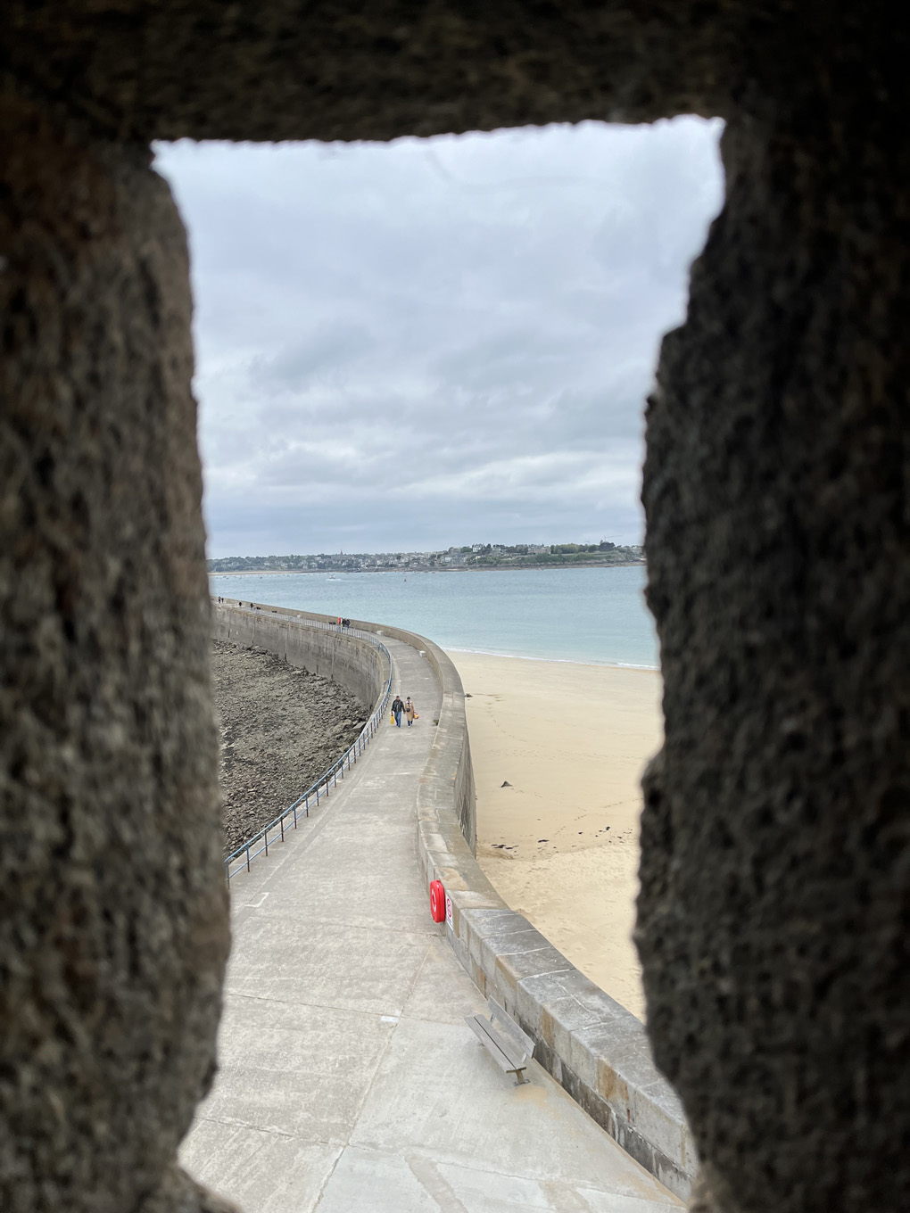 A framed view of a distant cliff with houses