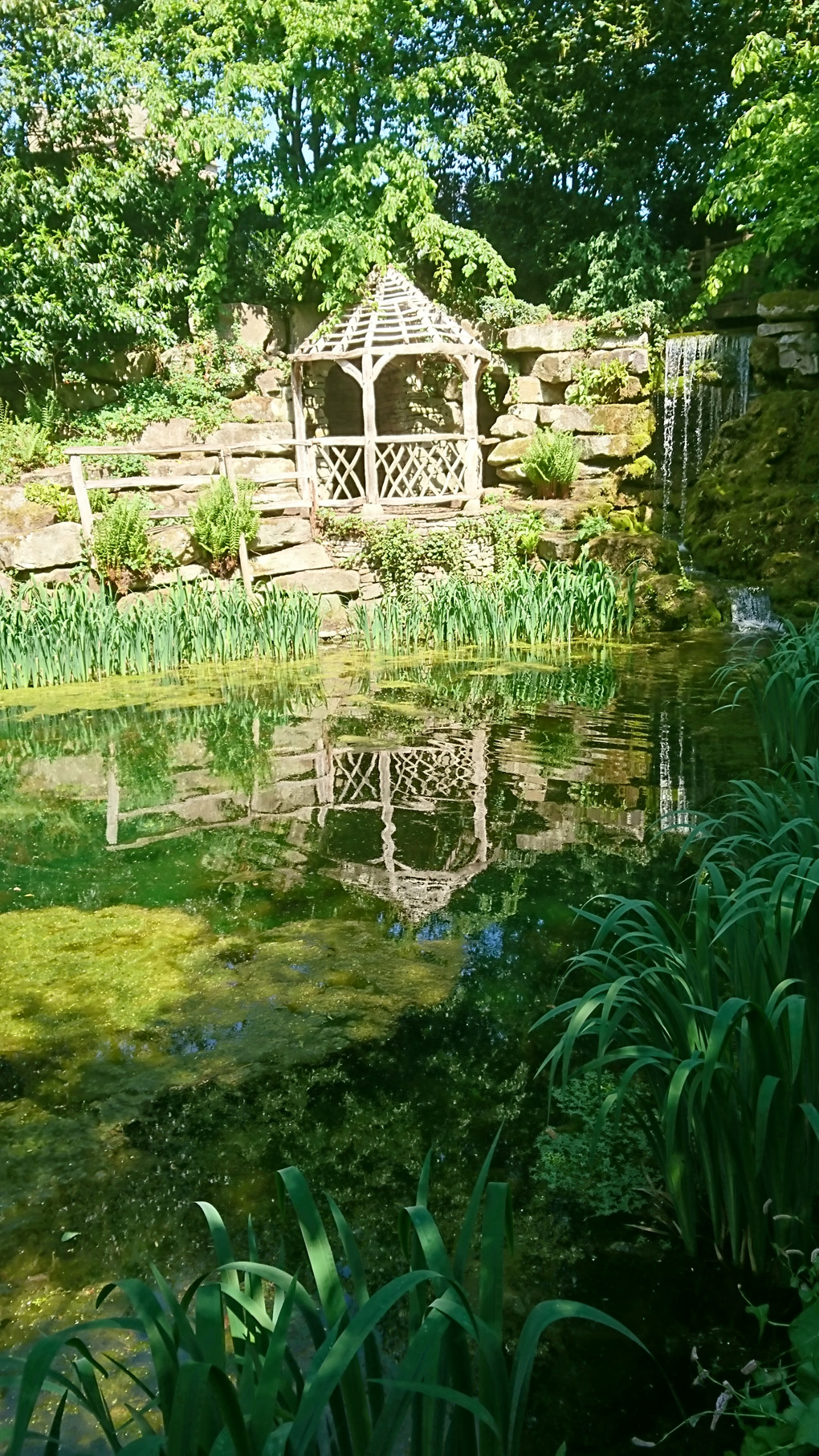 A beautiful sunken garden with a small gazebo overlooking a good sized pond. The garden is one of many at Hampton Castle in Herefordshire, all cleverly designed including a maze and a river walk. The house is built like a small castle, an experience for another day. Lovely place to visit.